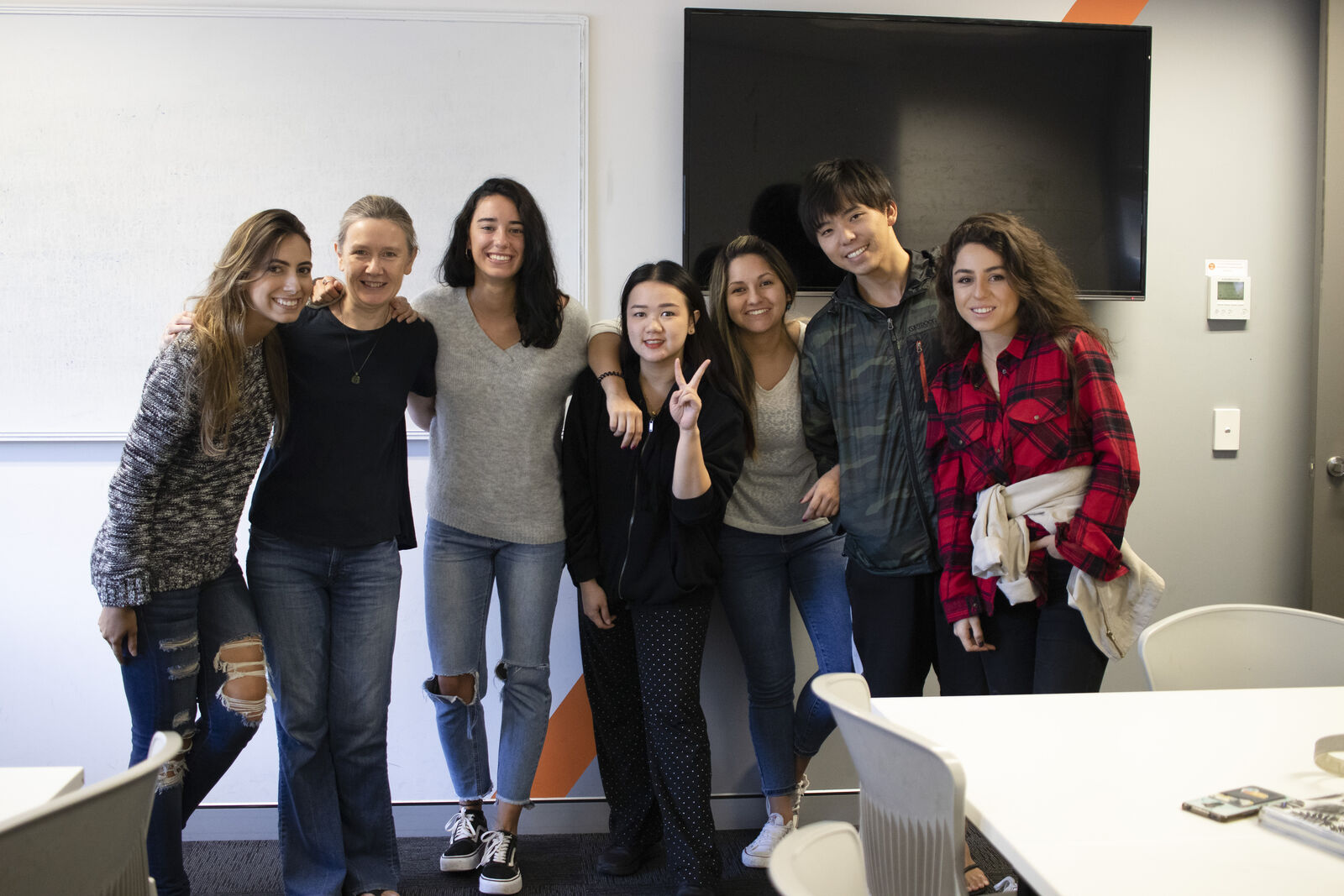 Students of many nationalities smiling together in the classroom